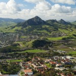 An aerial shot of San Luis Obispo and surrounding area with a high view some of the seven sisters mountains in the background.