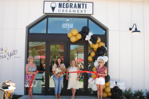 Group picture of four people in front of Negranti Creamery storefront, posing for a ribbon cutting photo.