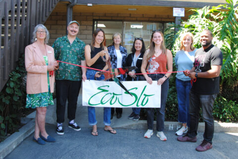 Picture of a group of people in front of ECOSLO building during a ribbon cutting ceremony.