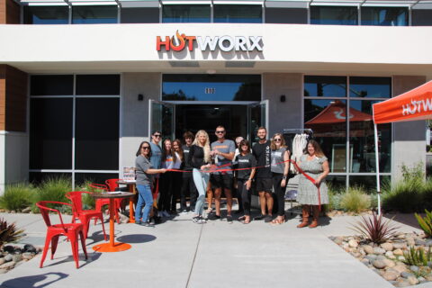 Group of people standing in front of Hotworks SLO for ribbon cutting