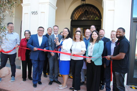 Group of People standing in front of HASLO's newly renovated Anderson Hotel for a ribbon cutting