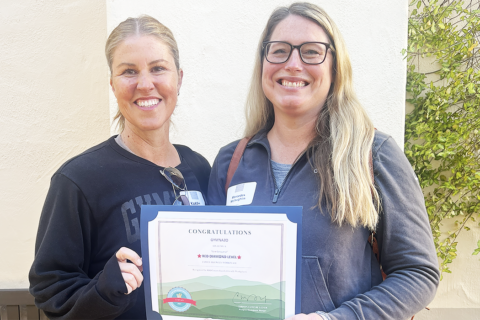 Two women from Gymnazo posing with a Family Friendly Workplace Award