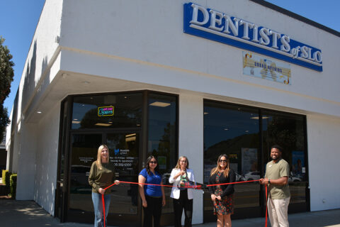 group shot of a ribbon cutting in front of Dentists of SLO