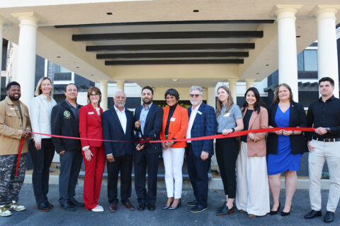 Group photo of ribbon cutting ceremony in front of Courtyard by Marriot San Luis Obispo Hotel