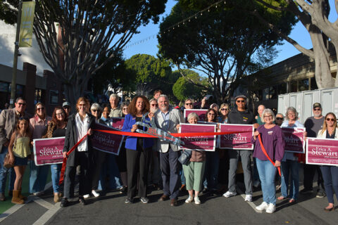 Group of people posing for ribbon cutting for Erica A. Stewart who is re-running for mayor of the City of SLO 2026