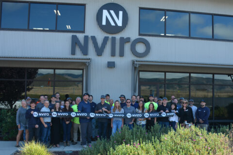 group shot of people in front of the NVIRO building in SLO County taking a ribbon cutting photo